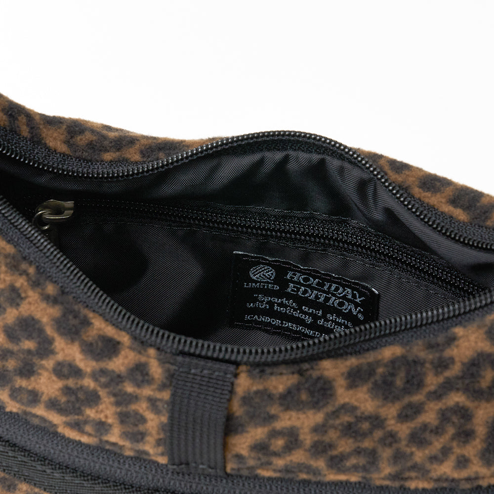 Crescent Bag in Leopard: main compartment unzipped, Holiday Edition label inside