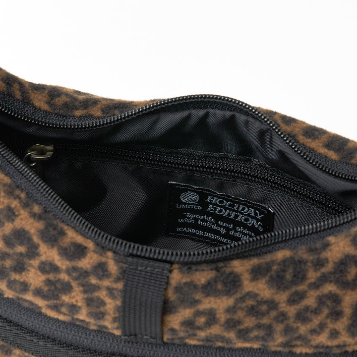 Crescent Bag in Leopard: main compartment unzipped, Holiday Edition label inside