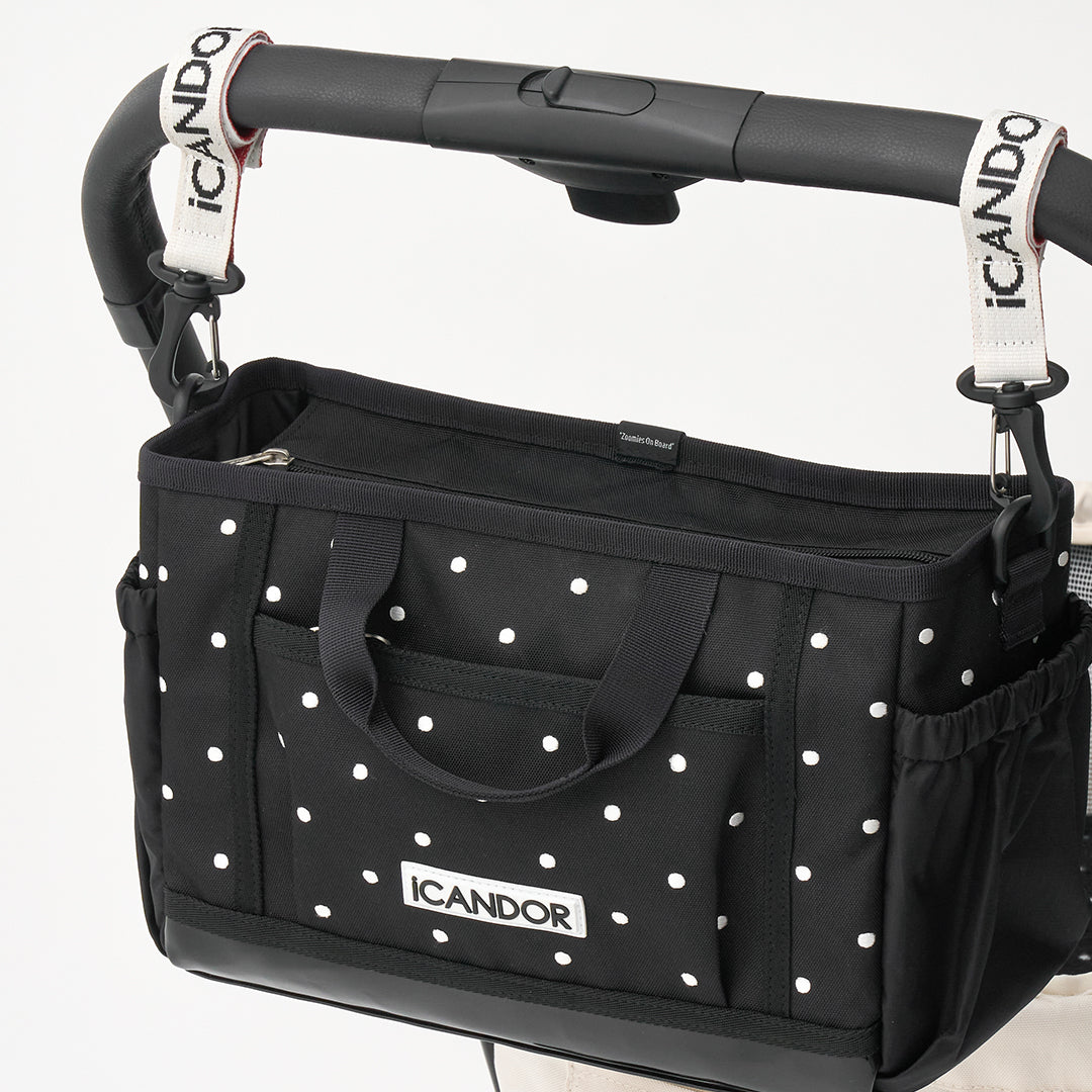 Urban Stroll Bag in Polka Dot: hung on a stroller handle with the stroller straps