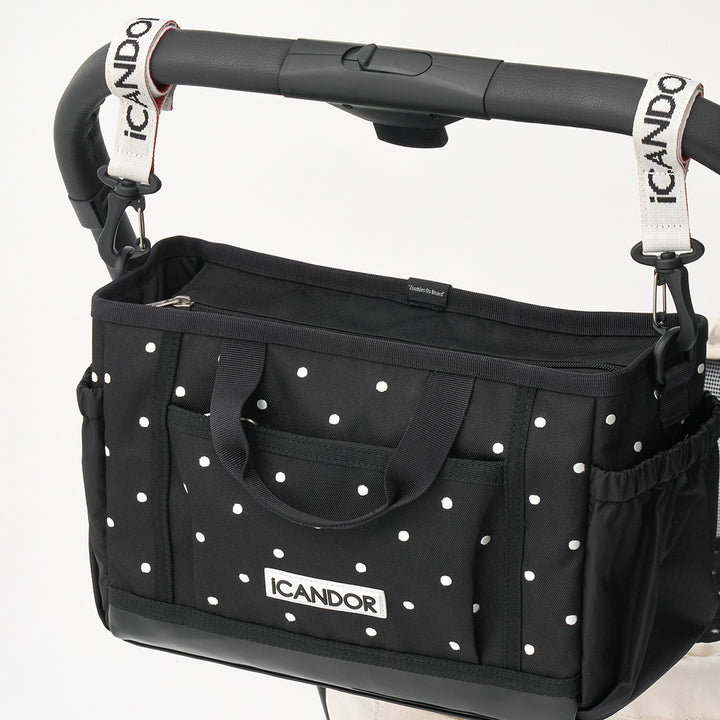 Urban Stroll Bag in Polka Dot: hung on a stroller handle with the stroller straps