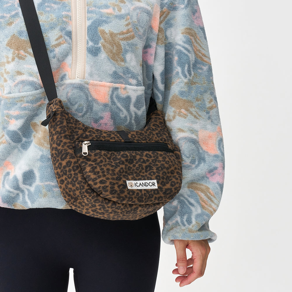 Crescent Bag in Leopard: worn crossbody over a fleece jacket