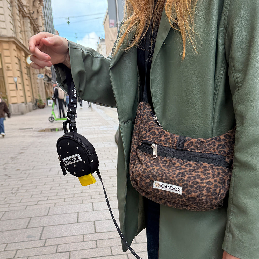 Crescent Bag in Leopard: worn crossbody on a city street with a leash and Polka Dot Dingle Dangle Bag